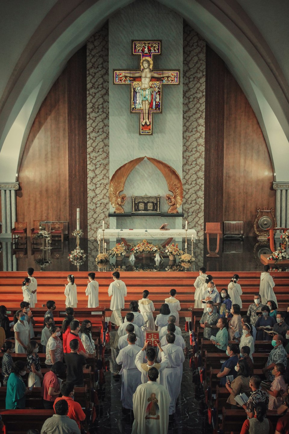 Clergy walk toward the altar during a church service.